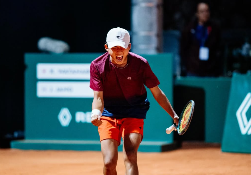 Tennis player serving during a match